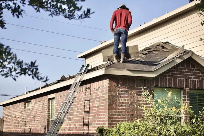 Professional roofer working on a residential roof in Shoultes